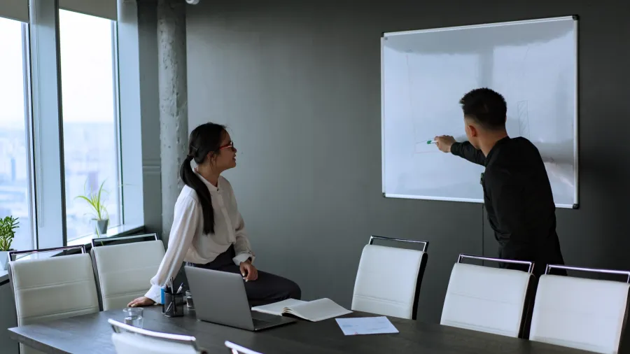 Photo by Mikhail Nilov: https://www.pexels.com/photo/woman-in-white-long-sleeves-looking-at-the-man-writing-on-white-board-8101764/